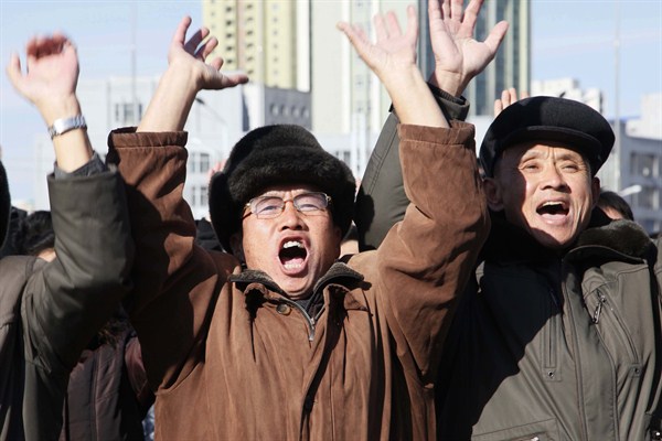 People cheer as they watch a news broadcast announcing North Korean leader Kim Jong Un's order to test-fire a newly developed inter-continental ballistic missile, Pyongyang, North Korea, Nov. 29, 2017 (AP photo by Jon Chol Jin).