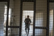 A member of the U.S.-backed Syrian Democratic Forces walks inside a prison built by Islamic State fighters, Raqqa, Syria, Oct. 20, 2017 (AP photo by Asmaa Waguih).