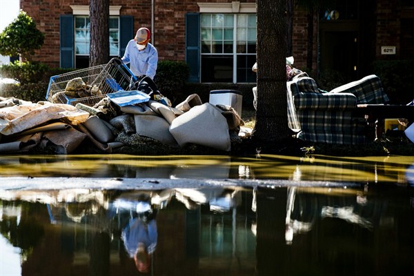 Homeowner Sohail Soomro dumps debris on his front yard in the aftermath of Hurricane Harvey, Katy, Texas, Sept. 7, 2017 (AP photo by Matt Rourke).