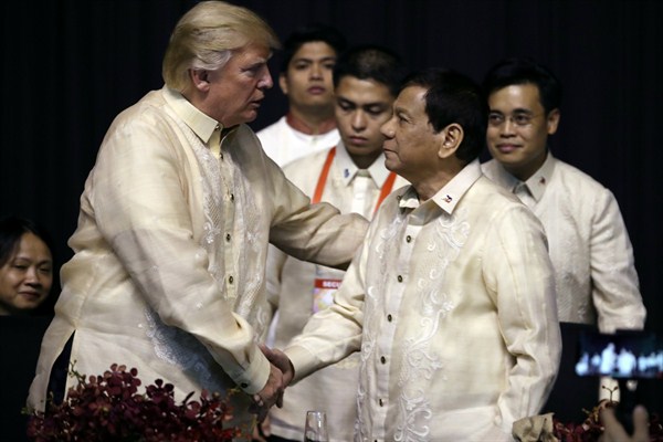 U.S. President Donald Trump shakes hands with Philippine President Rodrigo Duterte at an ASEAN summit dinner at the SMX Convention Center, Nov. 12, 2017 (AP photo by Andrew Harnik).
