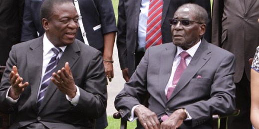 Emmerson Mnangagwa, left, chats with Zimbabwean President Robert Mugabe after a ceremony during which Mnangagwa was sworn in as vice president, Harare, Zimbabwe, Dec. 12, 2014 (AP photo by Tsvangirayi Mukwazhi).