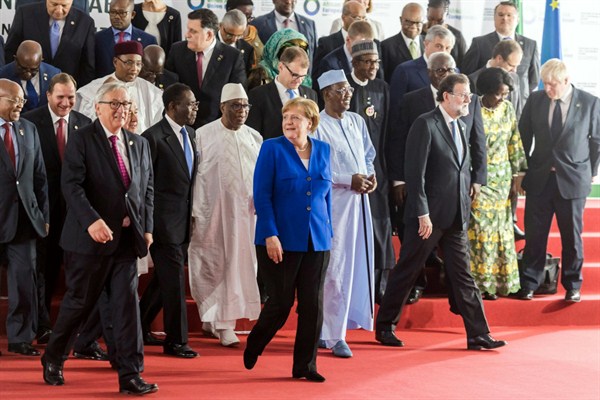 German Chancellor Angela Merkel steps off the podium with other EU and African leaders after a group photo at the latest EU-Africa summit, Abidjan, Cote d'Ivoire, Nov. 29, 2017 (AP photo by Geert Vanden Wijngaert).