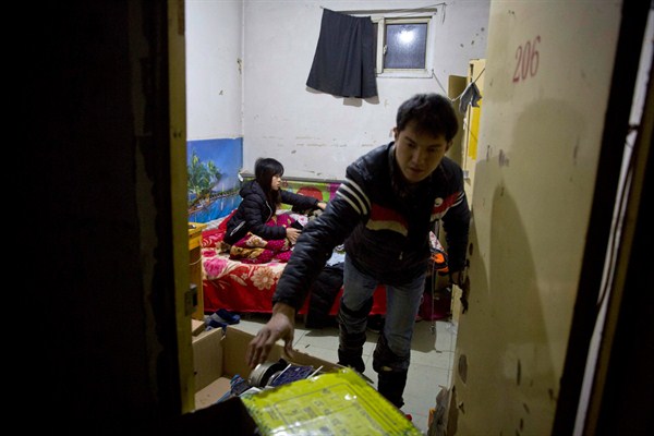 A couple of migrant workers prepare to leave their apartment ahead of an eviction deadline in the outskirts of Beijing, China, Nov. 27, 2017 (AP photo by Ng Han Guan).