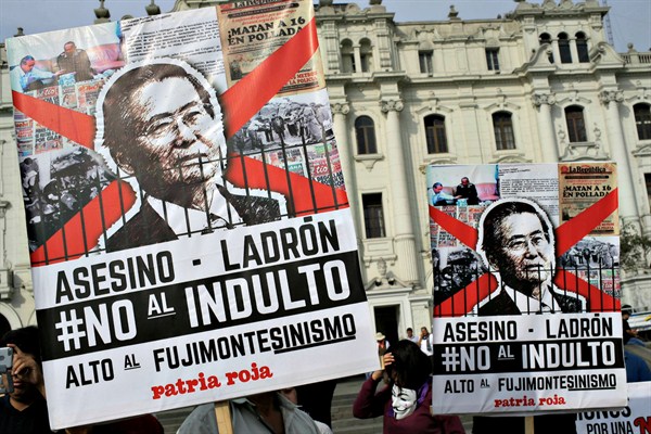 A protest against the pardon of former President Alberto Fujimori. The poster reads in Spanish, “assassin, thief, no to pardon,” Lima, Peru, Dec. 25, 2017 (AP photo by Martin Mejia).