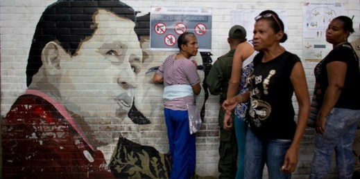 People search for their names on voter lists for mayoral elections at a polling station, Caracas, Venezuela, Dec. 10, 2017 (AP photo by Ariana Cubillos).
