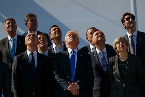 Donald Trump and other NATO leaders watch a flyover during a transfer ceremony at the new NATO headquarters, Brussels, May 25, 2017 (AP photo by Evan Vucci).