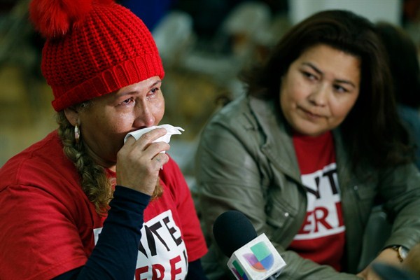 Salvadoran immigrants Diana Paredes, left, and Isabel Barrera react at a news conference following an announcement on Temporary Protected Status for nationals of El Salvador, Los Angeles, Jan. 8, 2018 (AP photo by Damian Dovarganes).