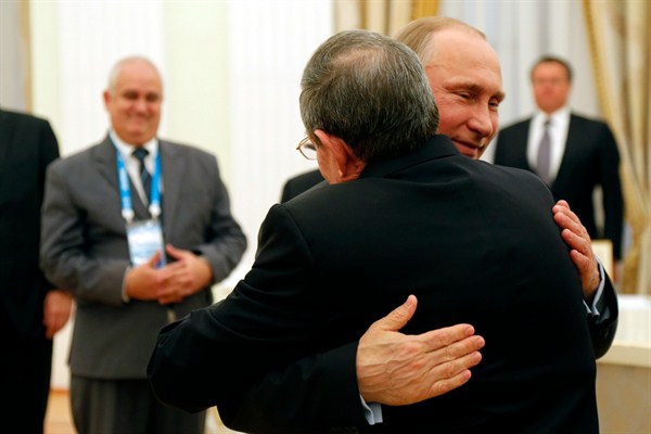 Russian President Vladimir Putin and Cuban President Raul Castro embrace during a meeting in Moscow, May 7, 2015 (Pool photo by Anatoly Maltsev via AP).