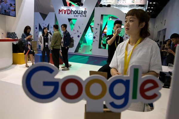 Visitors talk to staff members at a Google stand during the Global Mobile Internet Conference, Beijing, April 28, 2017 (AP photo by Ng Han Guan).