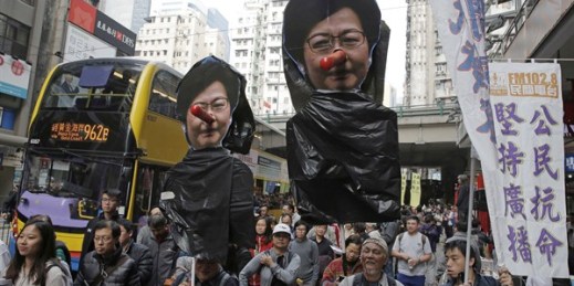 Pro-democracy protesters carry pictures of Hong Kong Chief Executive Carrie Lam during a rally, Hong Kong, Jan. 1, 2018 (AP photo by Kin Cheung).