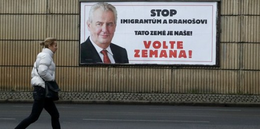 A woman walks past a poster for Czech presidential candidate Milos Zeman that reads, “Stop migrants and Drahos. This is our land! Vote Zeman!”, Prague, Jan. 24, 2018 (AP photo by Petr David Josek).