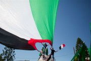 Residents from Gaza wave Palestinian and Egyptian flags to celebrate the Egypt-backed reconciliation agreement between Hamas and Fatah, Gaza City, Oct. 12, 2017 (AP photo by Khalil Hamra).