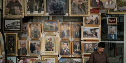 A man sits outside a store selling photos of Kurdish President Masoud Barzani and members of his family, Irbil, Iraq, Oct. 29, 2017 (AP photo by Felipe Dana).