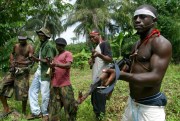 Ijaw millitants carry Russian-made AK-47 rifles in Okorota, Nigeria, June. 25, 2004 (AP photo by George Osodi).