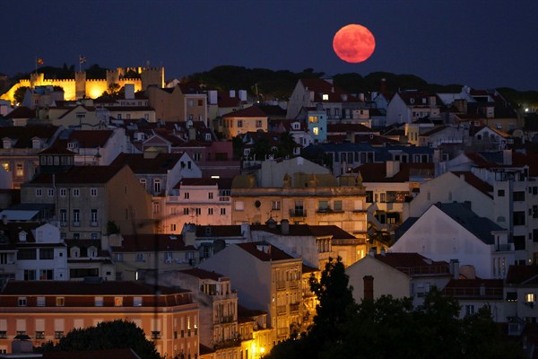 The full moon rises behind the Castle of Saint George in Lisbon, Portugal, Sept. 6, 2017 (AP photo by Armando Franca).
