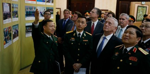 Vietnam’s defense minister, Ngo Xuan Lich, left, and U.S. Secretary of Defense Jim Mattis, second from right, view a photo exhibition on Vietnam-U.S. military cooperation, Hanoi, Vietnam, Jan. 25, 2018 (Pool photo via AP).