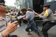 Police officers arrest a supporter of independence for West Papua during a rally in Jakarta, Indonesia, Aug. 15, 2017 (AP photo by Tatan Syuflana).