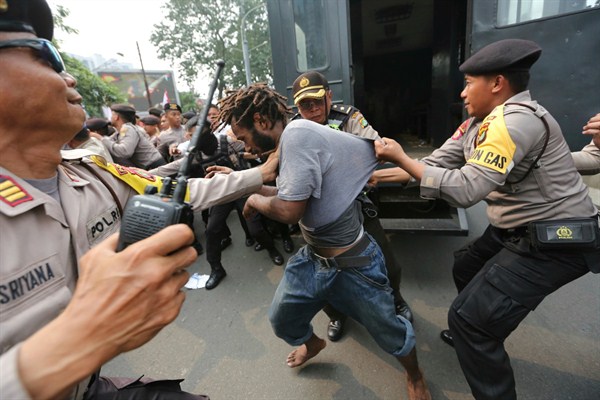 Police officers arrest a supporter of independence for West Papua during a rally in Jakarta, Indonesia, Aug. 15, 2017 (AP photo by Tatan Syuflana).