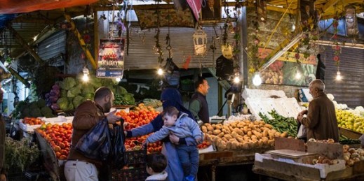 Parents with their young children shop for vegetables in downtown Amman, Jordan, Dec. 2, 2017 (AP photo by Lindsey Leger).