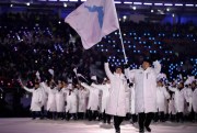 North Korea’s Hwang Chung Gum and South Korea’s Won Yun-jong carry the flag of Korean unification during the opening ceremony of the 2018 Winter Olympics in Pyeongchang, South Korea, Feb. 9, 2018 (AP photo by Vadim Ghirda).