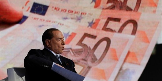 Italian former Prime Minister Silvio Berlusconi, backdropped by Euro banknotes, gestures during the recording of a talk show on Italian state television, Rome, Jan. 11, 2018 (AP photo by Andrew Medichini).