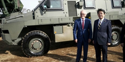 Australian Prime Minister Malcolm Turnbull and Japanese counterpart Shinzo Abe stand in front of an Australian-built Bushmaster Protected Mobility Vehicle, Funabashi, Japan, Jan. 18, 2018 (AP photo by Eugene Hoshiko).