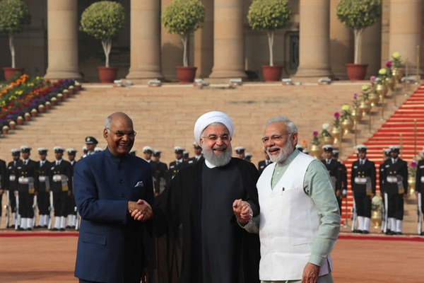 Iranian President Hassan Rouhani holds the hands of Indian President Ram Nath Kovind and Prime Minister Narendra Modi during a ceremonial reception, New Delhi, India, Feb. 17, 2018 (AP photo by Manish Swarup).