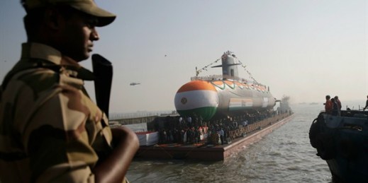 A security man stands guard as Karanj, India's third Scorpene class submarine, is set afloat during a launch ceremony, Mumbai, India, Jan. 31, 2018 (AP photo by Rafiq Maqbool).