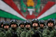Mexican soldiers look up toward President Enrique Pena Nieto as they ride past the National Palace during the annual Independence Day military parade, Mexico City, Sept. 16, 2016 (AP photo by Rebecca Blackwell).