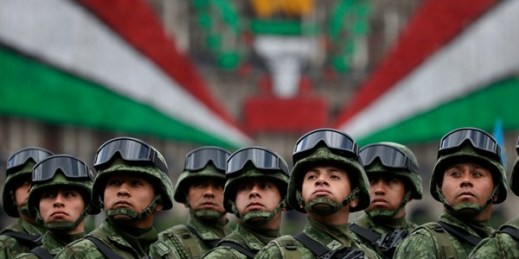 Mexican soldiers look up toward President Enrique Pena Nieto as they ride past the National Palace during the annual Independence Day military parade, Mexico City, Sept. 16, 2016 (AP photo by Rebecca Blackwell).
