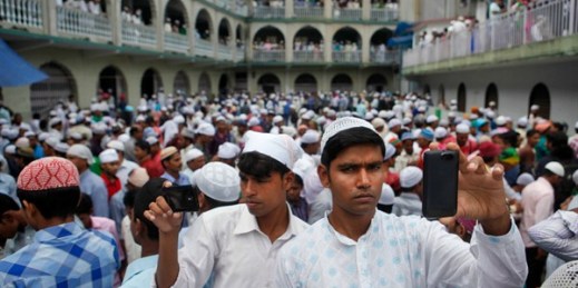 Nepali Muslims take photos after they offer prayers on Eid al-Fitr at a mosque in Kathmandu, July 18, 2015 (AP photo by Niranjan Shrestha).