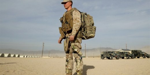 A U.S. Marine wears knee braces and a backpack that harvest energy from his movements during an exhibition of green energy technology, Twentynine Palms, California, Dec. 7, 2016 (AP photo by Gregory Bull).