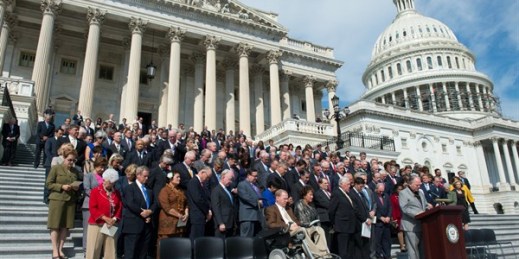 Members of the House of Representatives bow their heads in prayer during a ceremony on Capitol Hill in Washington marking the 15th anniversary of the Sept. 11 attacks, Sept. 9, 2016 (AP photo by Molly Riley).