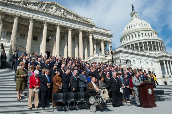 Members of the House of Representatives bow their heads in prayer during a ceremony on Capitol Hill in Washington marking the 15th anniversary of the Sept. 11 attacks, Sept. 9, 2016 (AP photo by Molly Riley).