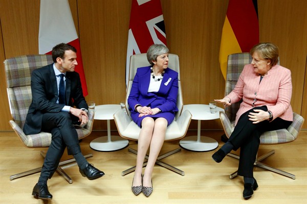 French President Emmanuel Macron, British Prime Minister Theresa May and German Chancellor Angela Merkel meet on the sidelines of an EU summit, Brussels, March 22, 2018 (Pool photo via AP by Francois Lenoir).
