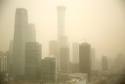 Dust envelops the skyscrapers in the central business district in Beijing, China, March 28, 2018 (AP photo by Mark Schiefelbein).