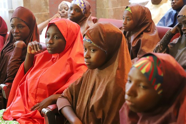 Recently freed schoolgirls from the Nigerian town of Dapchi attend a meeting with President Muhammadu Buhari, Abuja, Nigeria, March 23, 2018 (AP photo by Azeez Akunleyan).