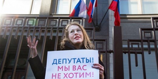 Russian presidential candidate Ksenia Sobchak attends a demonstration against sexual harassment, holding a placard reading “Deputies, we don’t want you!”, Moscow, March 8, 2018 (AP photo by Alexander Zemlianichenko).