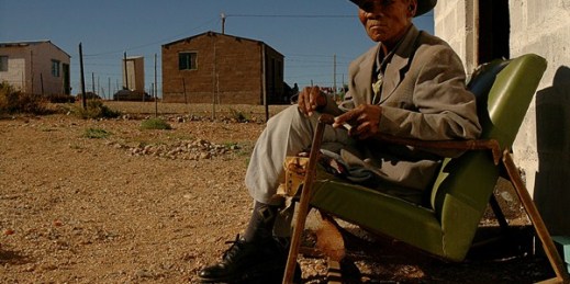 Jan Christians sits outside his home in the Richtersveld area, where locals live as they await the outcome of a lands claim action, North Western Cape Province, South Africa, March 2005 (AP photo by Mujahid Safodien).