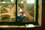 A Sri Lankan Muslim boy looks through a broken window of a vandalized mosque, Diana, Sri Lanka, March 9, 2018 (AP photo by Tharaka Basnayaka).