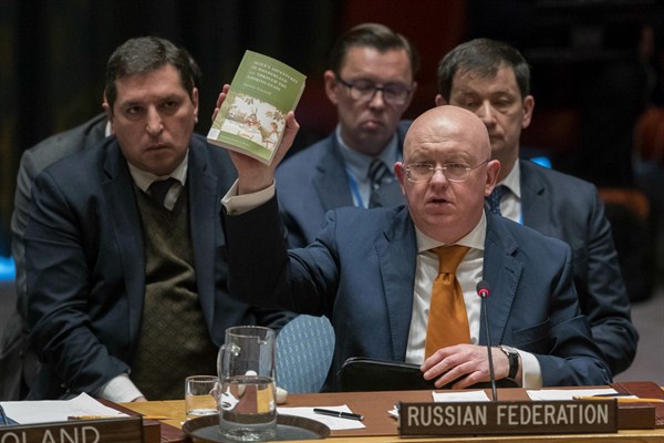 Russian Ambassador to the United Nations Vassily Nebenzia holds up a copy of “Alice’s Adventures in Wonderland” as he speaks during a Security Council meeting, New York, April 5, 2018 (AP photo by Mary Altaffer).
