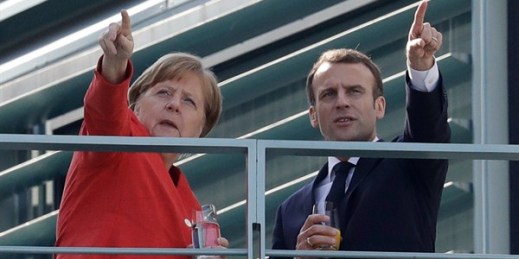 German Chancellor Angela Merkel and French President Emmanuel Macron take a break on the balcony of Merkel’s office after a meeting, Berlin, Germany, April 19, 2018 (AP photo by Michael Sohn).