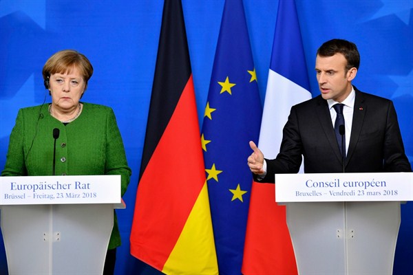 French President Emmanuel Macron and German Chancellor Angela Merkel participate in a press conference at the conclusion of an EU summit in Brussels,  March 23, 2018 (AP photo by Geert Vanden Wijngaert).