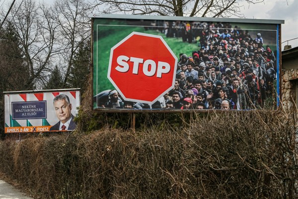 An election poster for Hungarian Prime Minister Viktor Orban is displayed on a roadside next to an official government anti-immigrant banner, Miskolc, Hungary, March 31, 2018 (Sipa photo by Michal Fludra via AP Images).