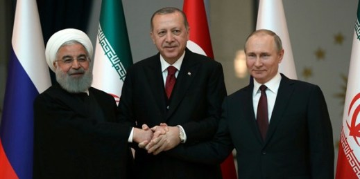 Iranian President Hassan Rouhani, Russian President Vladimir Putin and Turkish President Recep Tayyip Erdogan lock hands during a group photo, Ankara, Turkey, April 4, 2018 (Pool photo  by Tolga Bozoglu via AP).