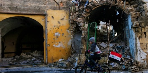 A Syrian boy rides his bike through the destruction of the once rebel-held Jalloum neighborhood in eastern Aleppo, Syria, Jan. 20, 2017 (AP photo by Hassan Ammar).