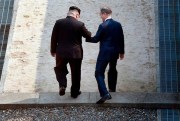 North Korean leader Kim Jong Un and South Korean President Moon Jae-in cross the military demarcation line in the border village of Panmunjom in the Demilitarized Zone, April 27, 2018 (Korea summit press pool photo via AP).