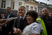 Dutch lawmaker Geert Wilders laughs with a supporter during a campaign stop in Heerlen, Netherlands, March 11, 2017 (AP photo by Muhammed Muheisen).