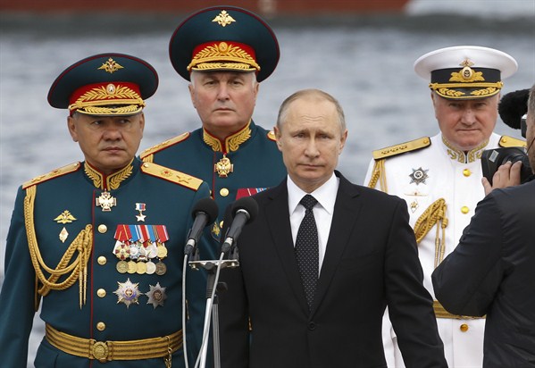 Russian President Vladimir Putin, flanked by top officials, attends a military parade during Russia’s Navy Day celebration, St. Petersburg, Russia, July 30, 2017 (AP photo by Alexander Zemlianichenko).