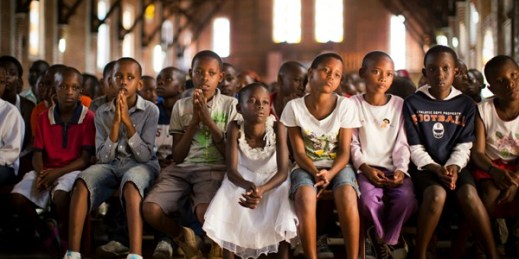 Rwandan children listen and pray during a Sunday morning service at the Saint-Famille Catholic church, the scene of many killings during the 1994 genocide, Kigali, Rwanda, April 6, 2014 (AP photo by Ben Curtis).